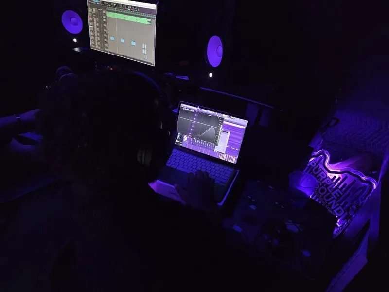 Dialing it in on the laptop, the Purple Sound neon burning on the table