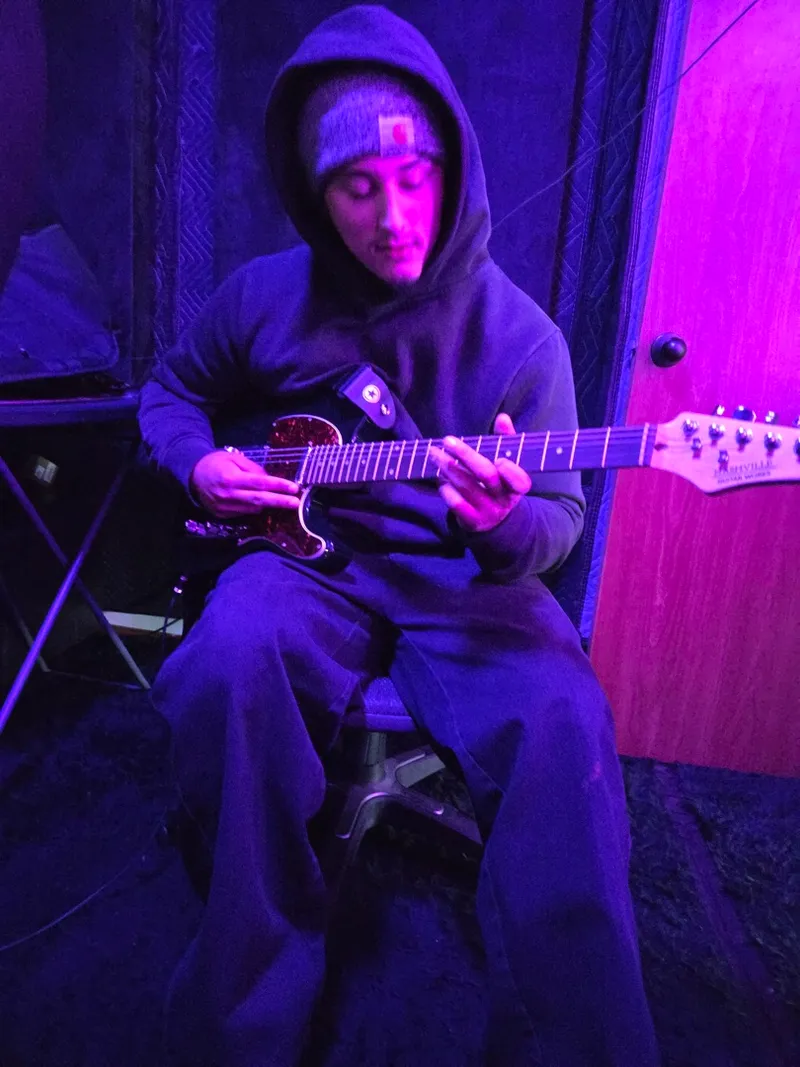 On the guitar under the purple