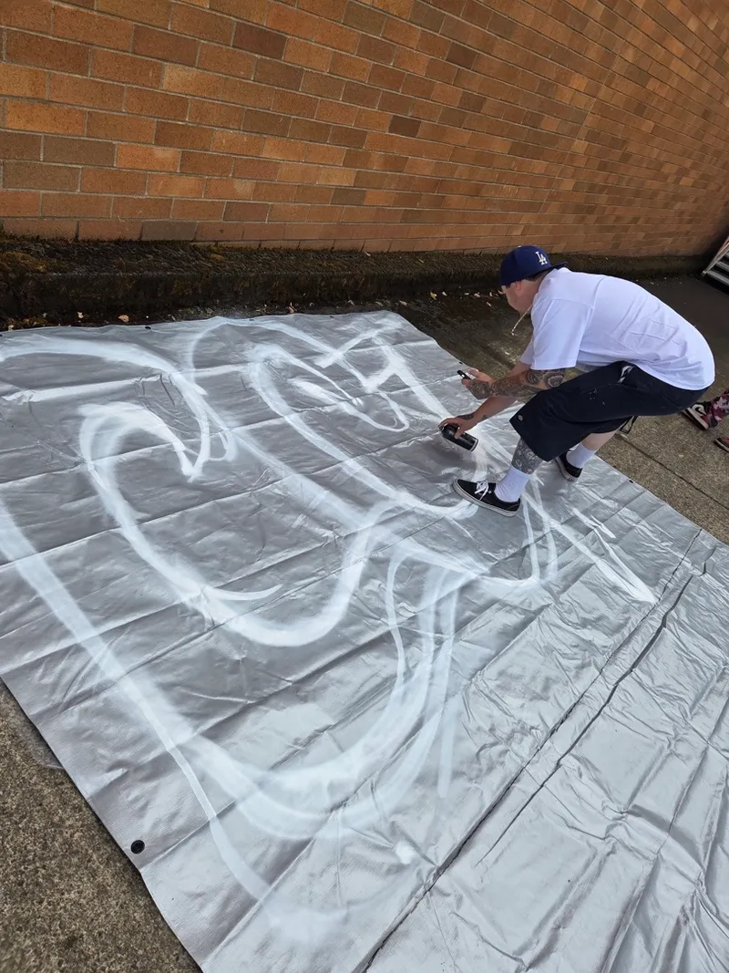 Midday — the outline goes down on a blank tarp