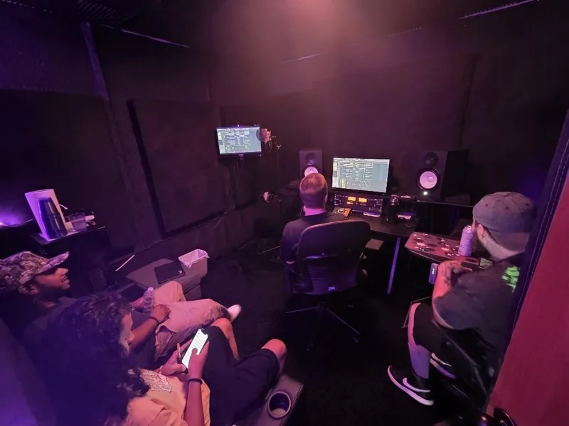The whole room at Purple Sound — the session running on both screens while the crew settles in