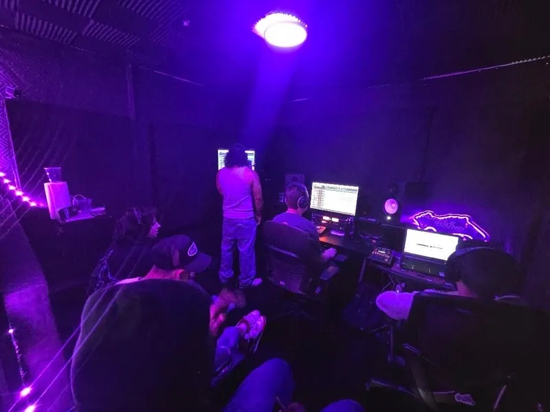 The whole room at Purple Sound under the purple light, everyone at the screens while the session runs