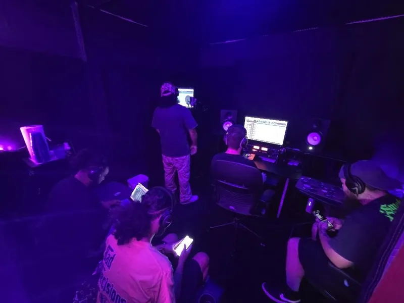 Mid-take from the corner — everyone locked in on their own mix