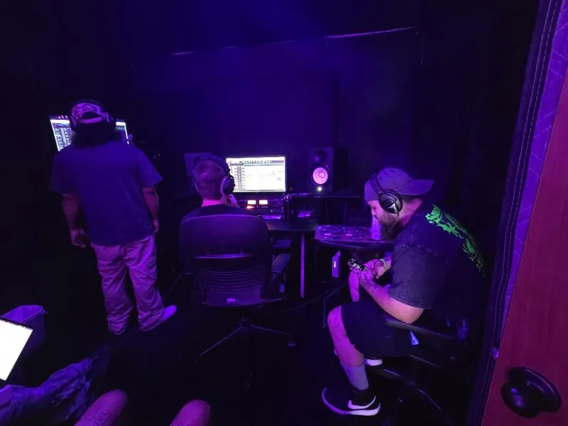 Three stations going at once — the booth screen, the desk, and the side table