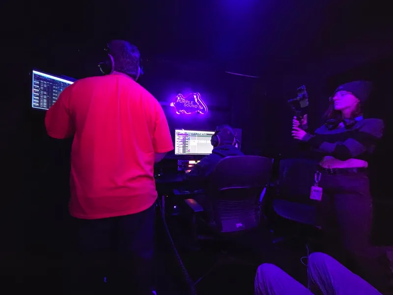 Up at the desk in the red shirt