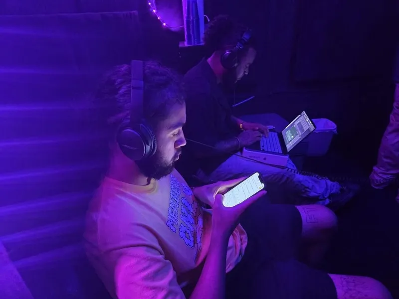 Writing the verse in headphones, phone in hand, the beat on the laptop next over